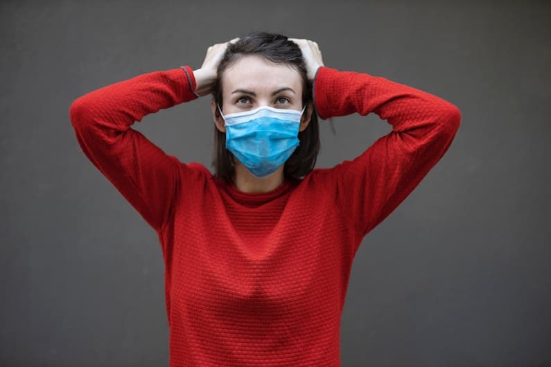 Anxious teenager wearing a Coronavirus facemask